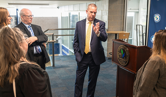 Assemblyman Scott Gray speaks to a group from the Roos House Mezzanine.