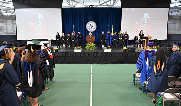 A wide shot of the Commencement 2025 stage at the start of the ceremony.