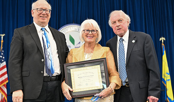 Judy Chase receives the Distinguished Citizen Award from Chairman Ronald O'Neil and President Zvi Szafran.