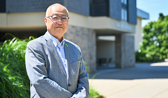 Dean Kenneth Rhee stands outside MacArthur Hall.