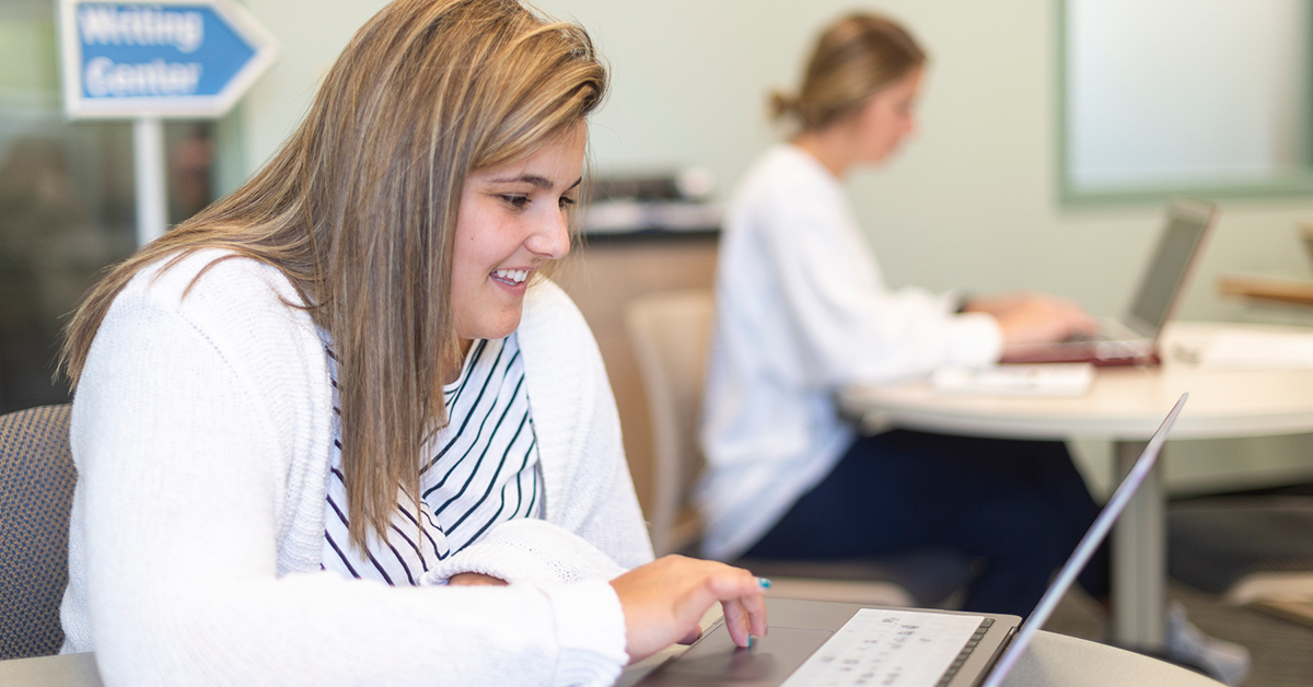 A student works on her laptop in the Learning Commons.