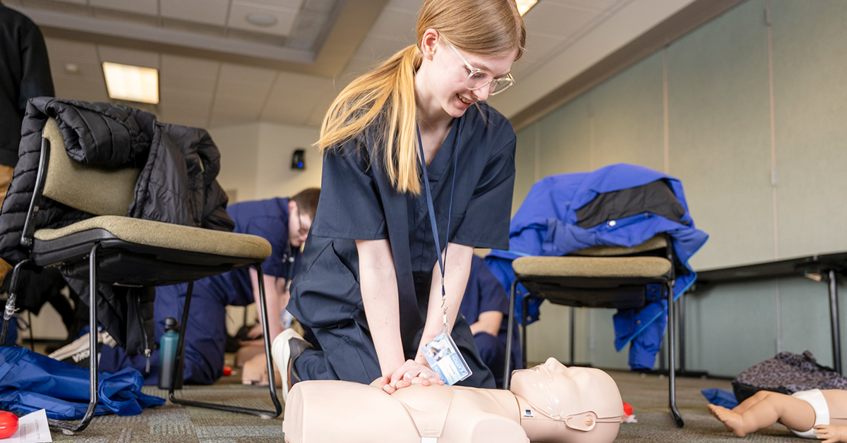 Student Elizabeth Vankennen performs CPR on a training mannikin.