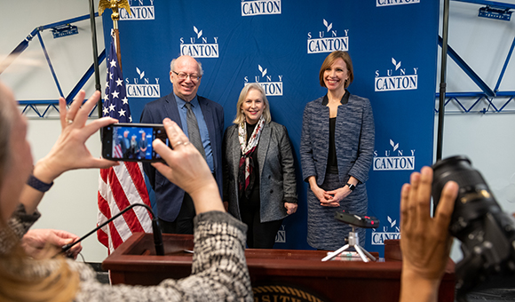 President Zvi Szafran, Senator Kirsten Gillibrand and Lenore VanderZee pose for a photo.