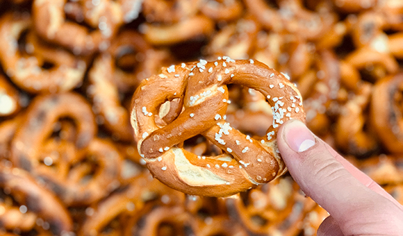 Close-up of a Martin's pretzel hovering over a mound of pretzels.