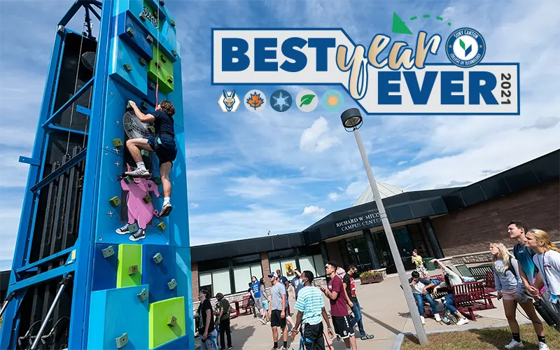 Best Year Ever - Student climbing a large blue wall in front of Miller Campus Center.