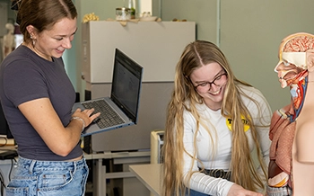 Students work with one of the new anatomy models purchased through a Carl D. Perkins Career and Technical Education grant.